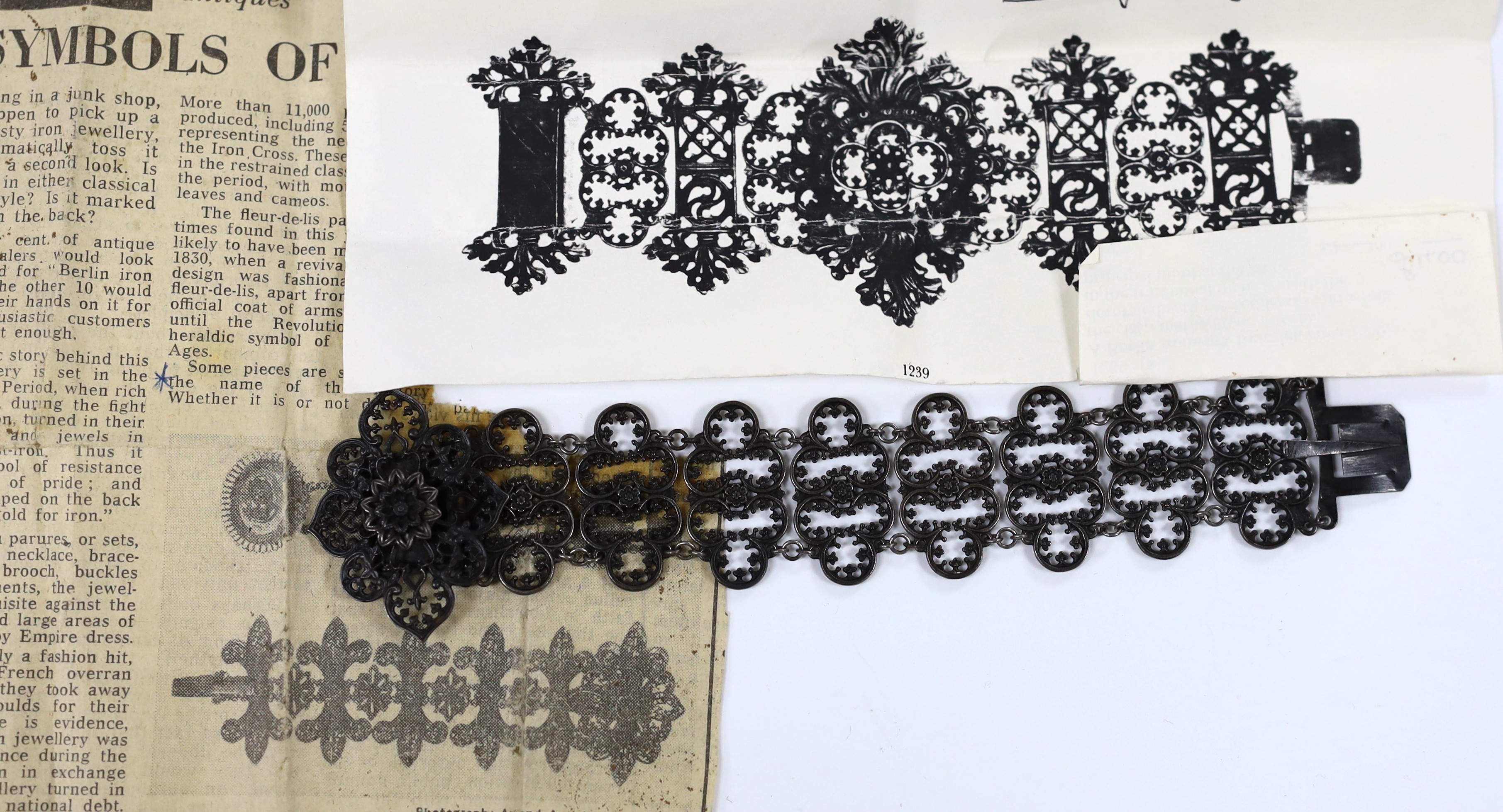 A 19th century Berlin iron work bracelet, with pierced cusped oval links and flower head clasp, stamped 'Geiss a Berlin', 17cm.